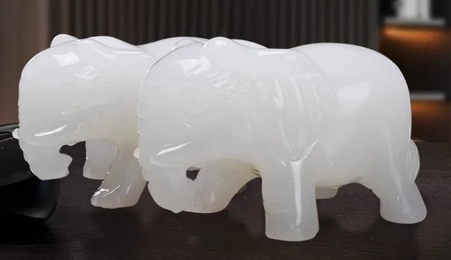 A pair of jade elephants decorate natural Afghan white jade