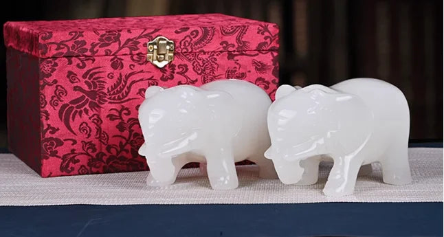A pair of jade elephants decorate natural Afghan white jade