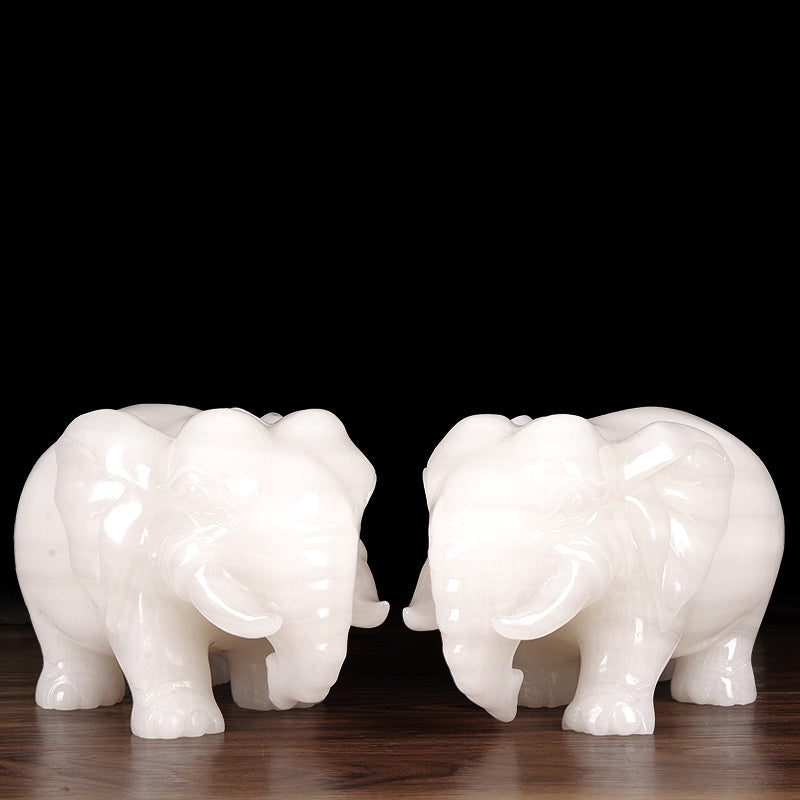 A pair of jade elephants decorate natural Afghan white jade