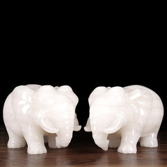 A pair of jade elephants decorate natural Afghan white jade
